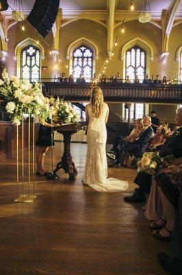 Ceremony arrangements on either side of the podium.