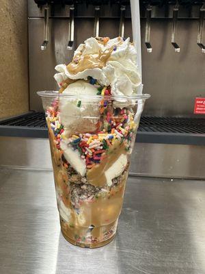 Large Reese's and peanut butter with sprinkles sundae