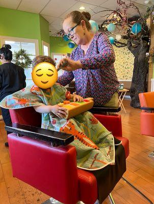 Getting his haircut by Karen