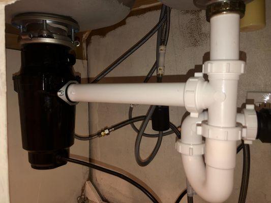 Garbage disposal installation with new plumbing.