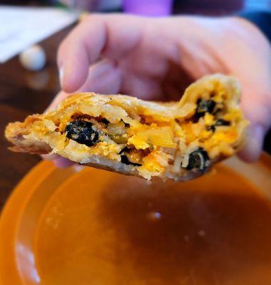 Veggie breakfast burrito hand pie with eggs, cheese, black beans, rice, onions and peppers