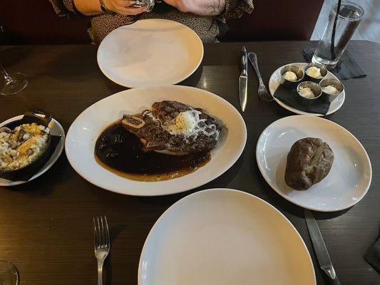 Cowboy ribeye with wild mushroom risotto and baked potato.