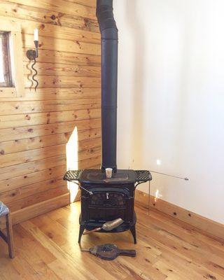 Wood stove in a cute cabin.