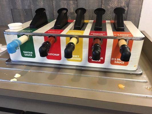 Dining room was dirty: this dispenser, tables needing wiped, crumbs on the floor, and trays piled up at the trash can dispenser.