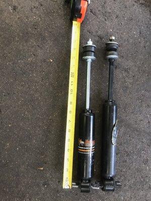 Their extended shocks (left) vs my monroe OEM shocks (right). Also too wide to go through the lower control arm.