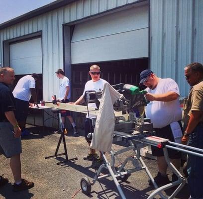 Local volunteers building picnic tables at Habitat