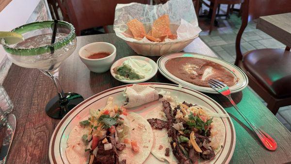 carne asada (steak) tacos, refried beans, chips and salsa, and margarita especial.