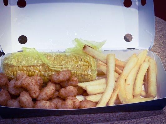 Kids meal popcorn shrimp, fries and corn on the cob.