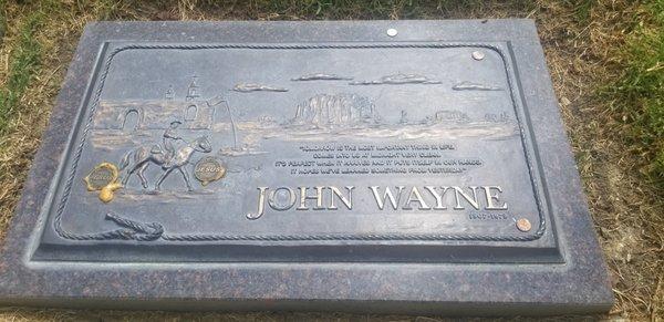 Desecrated: Coins glued to John Wayne's grave. #2