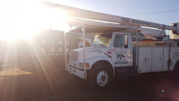 Bucket truck and wood-chip truck lined up to go at dawn's call.