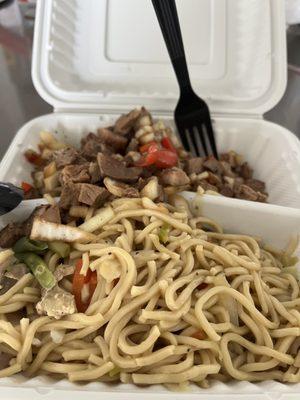 Pancit chicken noodles, and pork sisig in the back.