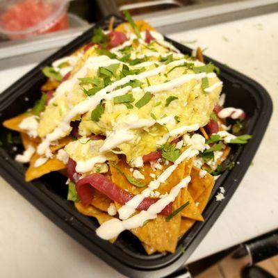 Chilaquiles, chips cooked to order, house made salsa, Pickled red onion, crema drizzle and cilantro