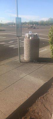 A AC TRANSIT TRASH CAN THAT IS FULL AND NEVER MAINTAINED ON SOUTHLAND DRIVE AT SOUTHLAND MALL.