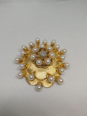 The stores new gold and pearl pin. Email or come in to try it on.