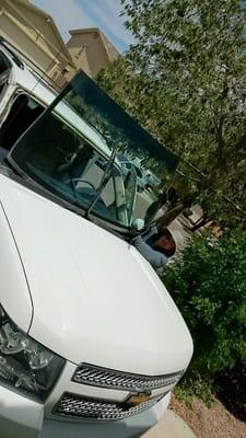 Here Hector is installing the new windshield for a 2011 Chevy Avalanche.