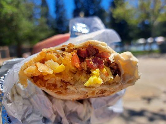 Breakfast burrito with bacon is yummy.