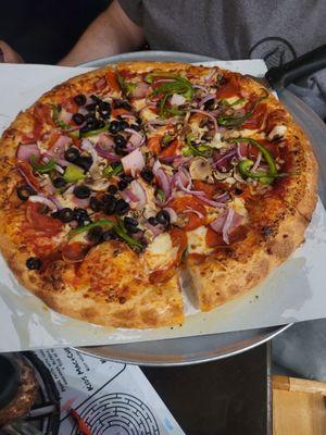 Super pizza, 8 slices, half black olives