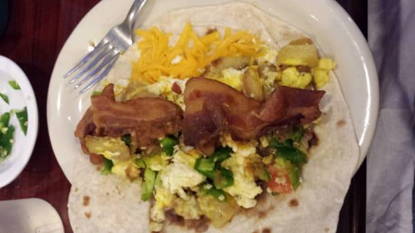 Breakfast taco with salsa is good and spicy but flavorful.