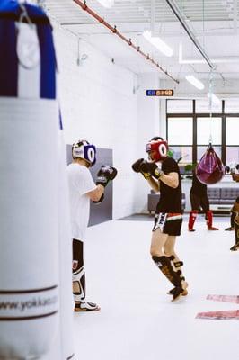 Students sparring during Muay Thai class.