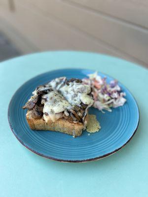 Mushroom Toast- Mushrooms sautéed in white wine and herbs piled on toasted Levain bread and topped with melted Gruyère cheese