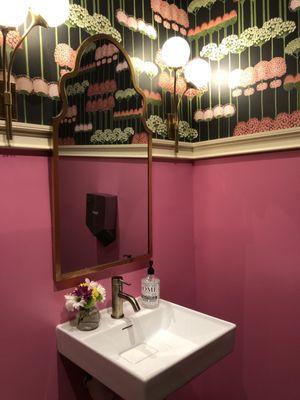 The all-genders bathroom - bright pink with beautiful wall paper featuring alliums