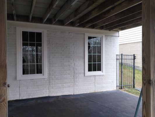 A photo of basement windows turned into egress size openings creating an official bedroom and beautiful light.