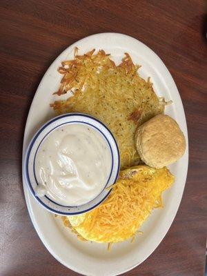 Ham and cheese omelette, hash browns and biscuit w/ gravy