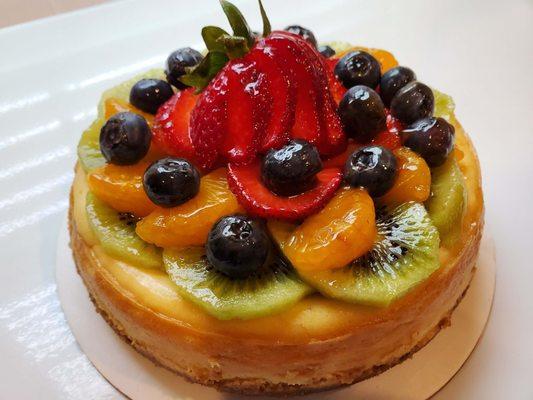 Vanilla cheesecake with mixed fruit on shortbread crust