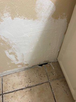 Hole in wall in the middle of being repaired.