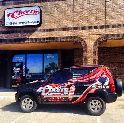 Cheers Unisex company vehicle and sign.