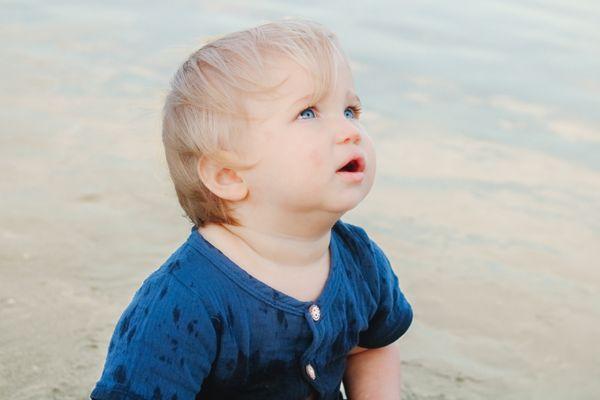 A child gazes towards the sky during a photoshoot