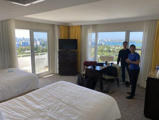 Sea View Hotel Room with view of Biscayne Bay, Miami, and ocean from balcony.