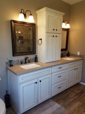 We removed the soffit above the vanity area giving it much more space and an open feeling. Also allowing room for the stacked cabinet.