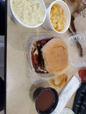 Brisket plae with potato salad, Mac and cheese, and BBQ sauce