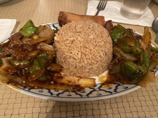 Lunch special pepper steak with fried rice and spring roll.