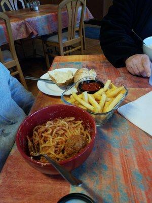 Spaghetti and meatballs with fries.