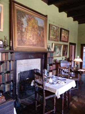 Living Room filled with books, paintings, and antiques