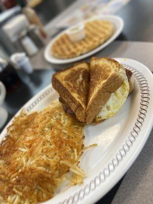 Texas Bacon egg & cheese melt with hashbrowns and a waffle of course