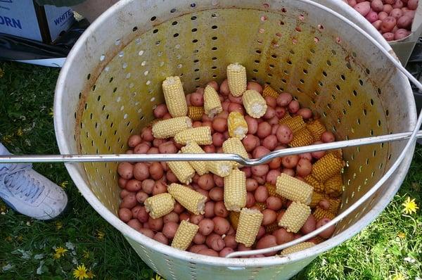 Potatoes and corn cook longer.  They went into the boiler first.