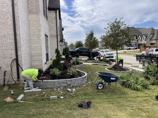 Crew building a slate chop block stone border adhesive together all around details are the key for a outstanding border.