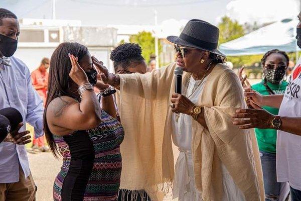 Pastor Carol E. Dixon prays to God in the Name of Jesus for people and she lays hands on them!!