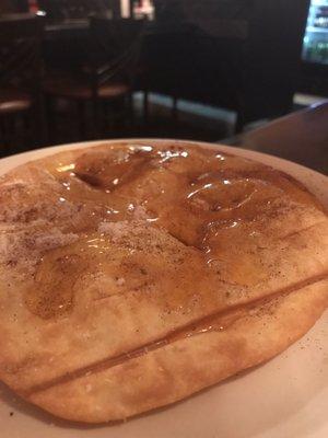 sopapilla drizzled with honey and dusted with cinnamon sugar