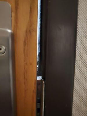 Closeup of gap from inside, about 3/8 inch. Deadbolt had about 1/4 in. engagement, not encouraging. Light shows through.