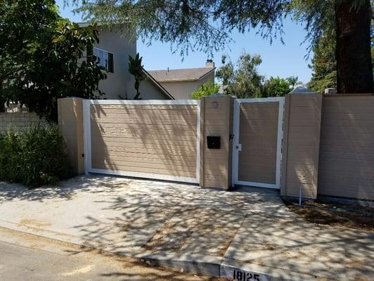 Composite wood fence 
With metal frame swing gate 
And pedestrian gate 
Also intercom system 
Reseda may 2016