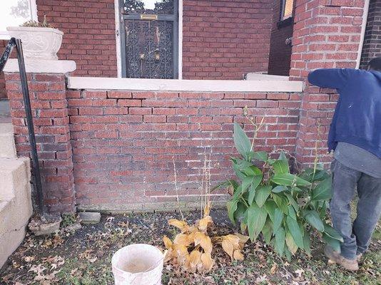 men in action, Raking out damaged mortar