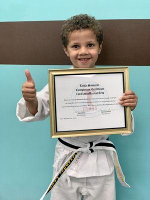 He did it!  Graduating from Little Samurai Program by earning his white-black stripe belt!  Way to go Champ!