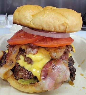 The Widow Maker!!!  Bring your appetite this bad boy is 9 0z. of angus beef, 4 slices of bacon, 3 slices of cheese and all the toppings!