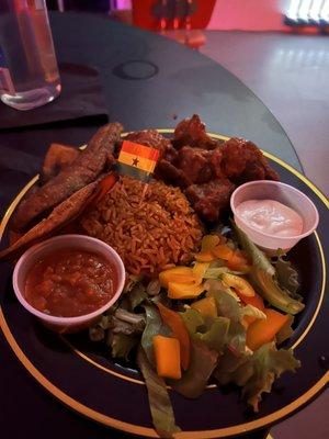 Stew goat with jollof rice, plantains and salad