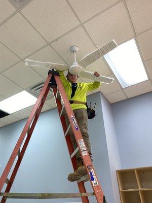 Andres installing a fan in a commercial building