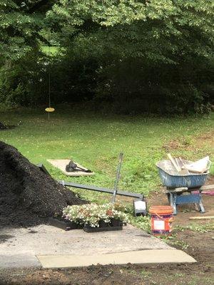 The concrete patched asphalt driveway...